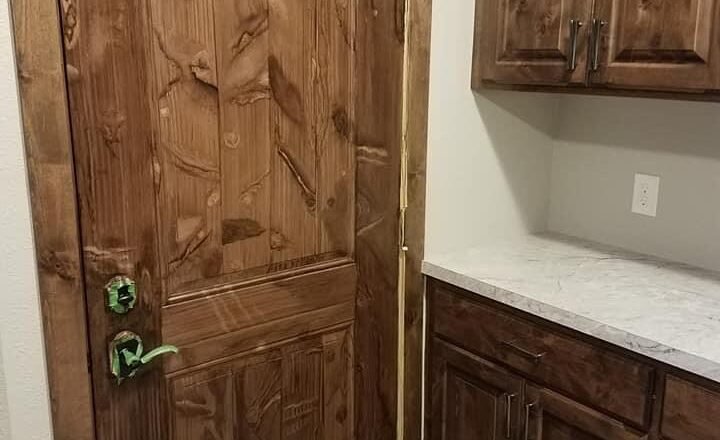 Woodgrain in knotty elder on a steel door